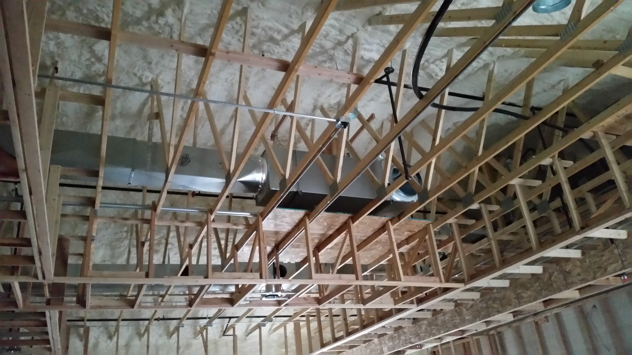 Attic trusses with new insulated duct runs installed